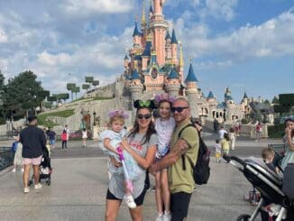 family pic in front of disney castle paris september 2022