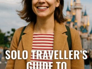 Smiling solo traveller at Disneyland Paris near Sleeping Beauty Castle with umbrella and backpack, for 2025 solo travel guide